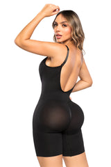 Woman wearing a black shapewear bodysuit on a white background